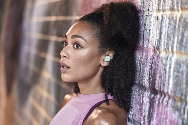 Jabra Elite 7 Active Mint Lifestyle Side Profile Brick Wall Medium