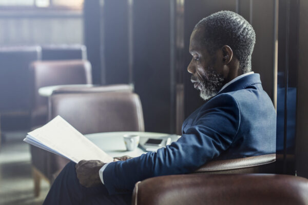 Elagant Businessman Reading Daily Newspaper at Cafe